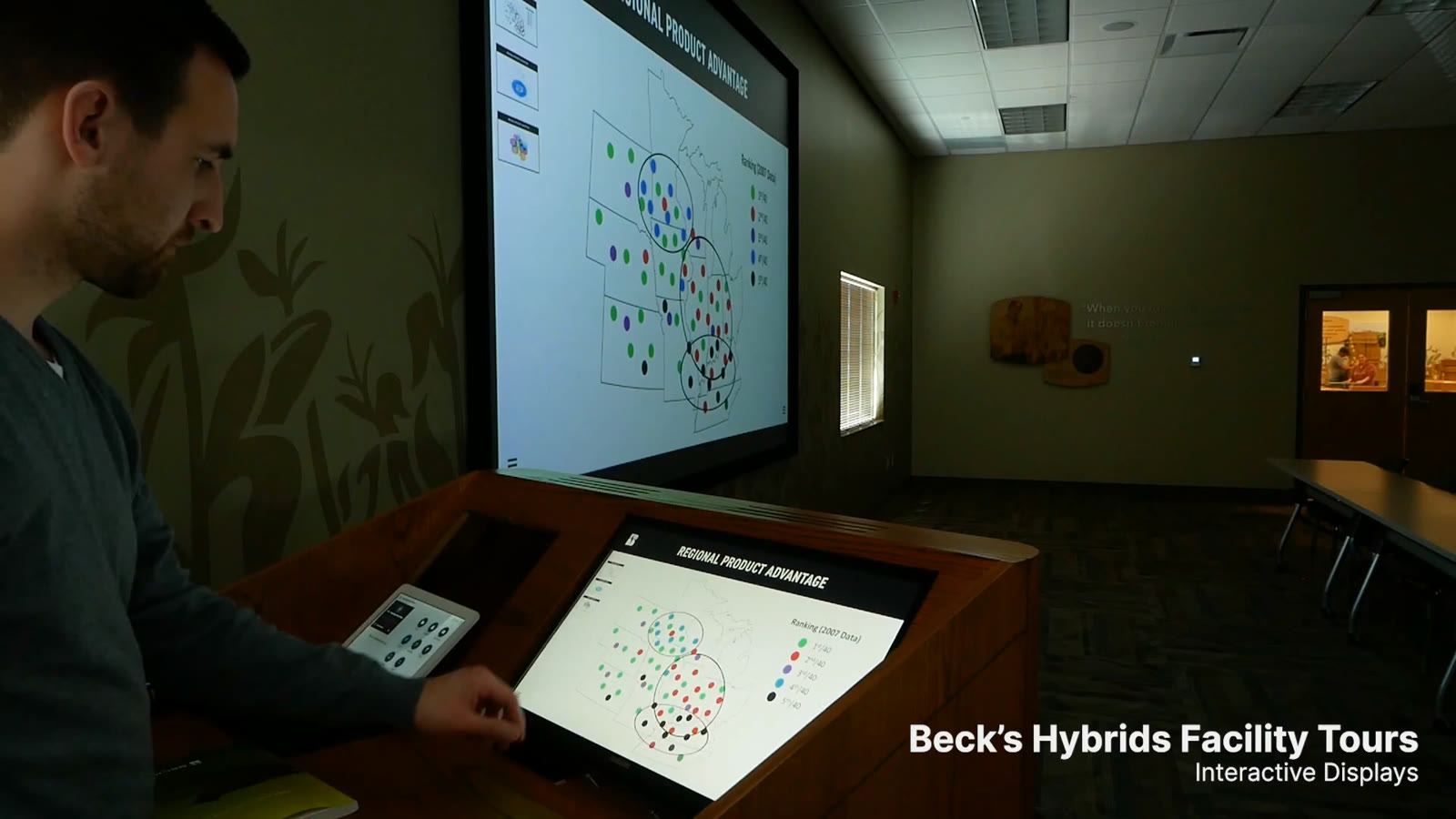 Podium touchscreen and wall display showing the same map during a Beck’s facility tour
