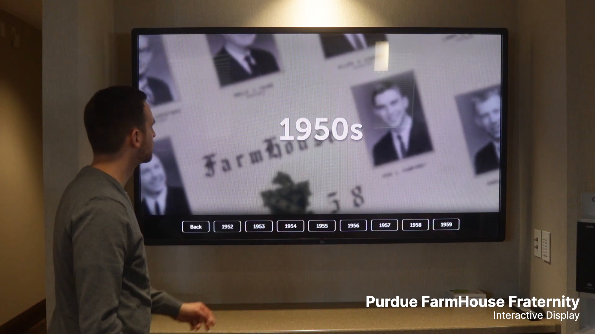 Spencer demonstrating the FarmHouse archive touchscreen and its year navigation